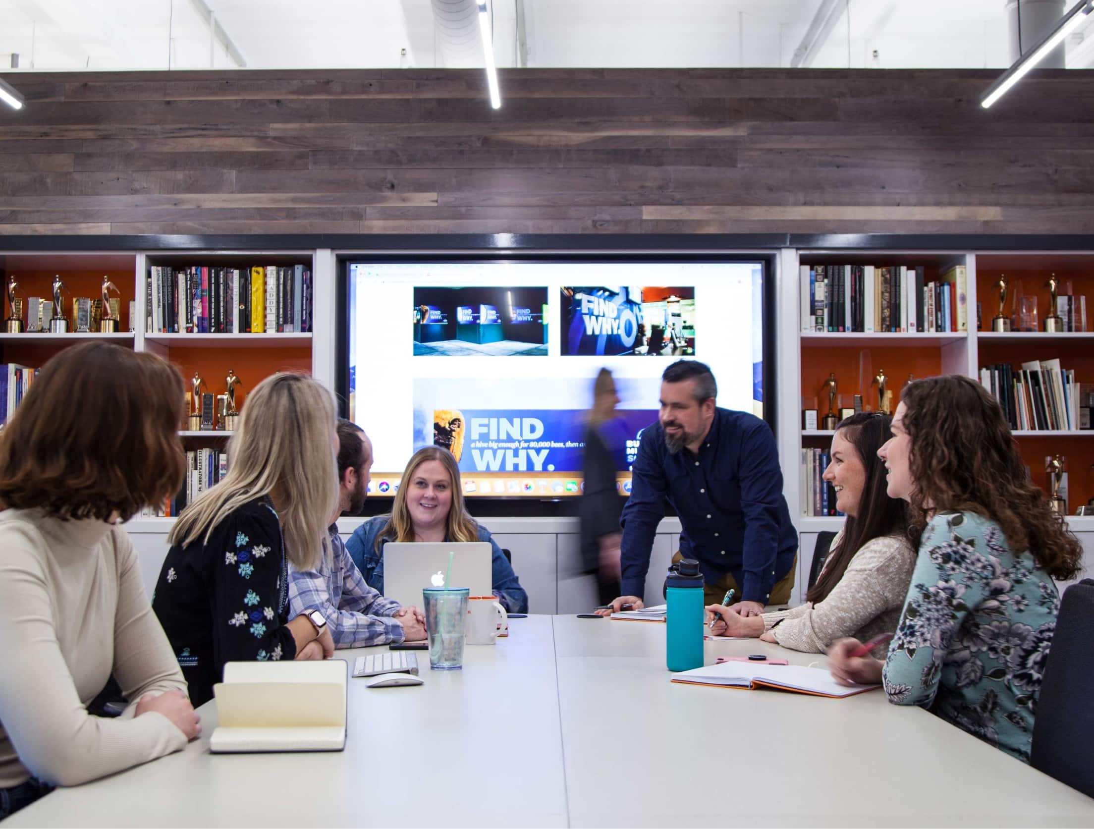 People working around a table in a conference room.